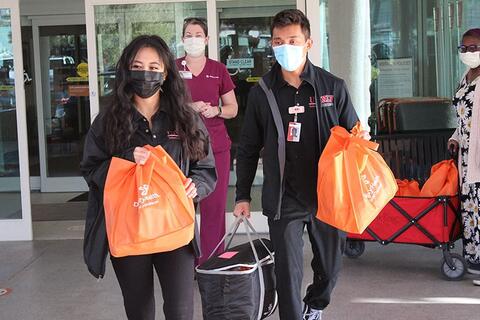 CommunityNursing-768x512.jpg Students outside holding supplies.